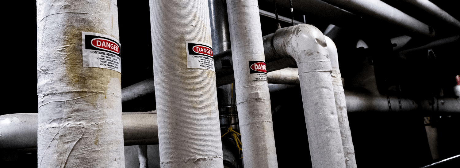 Encapsulated asbestos ducting with warning sign